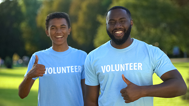 Migrant Support Charity in New Cross and London two men wearing blue volunteer t shirts